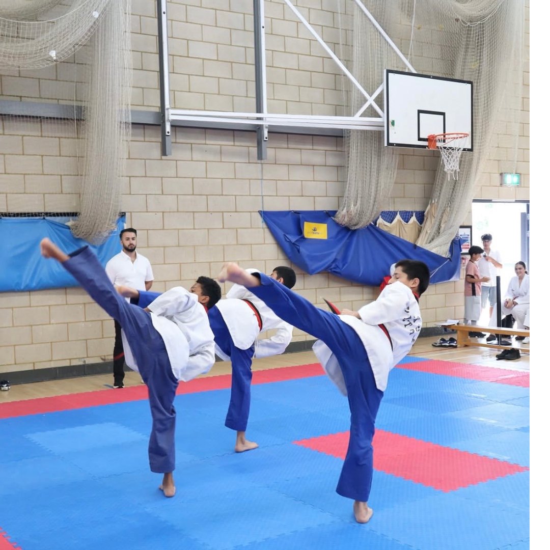 Cadets performing high side kicks in sparring uniform