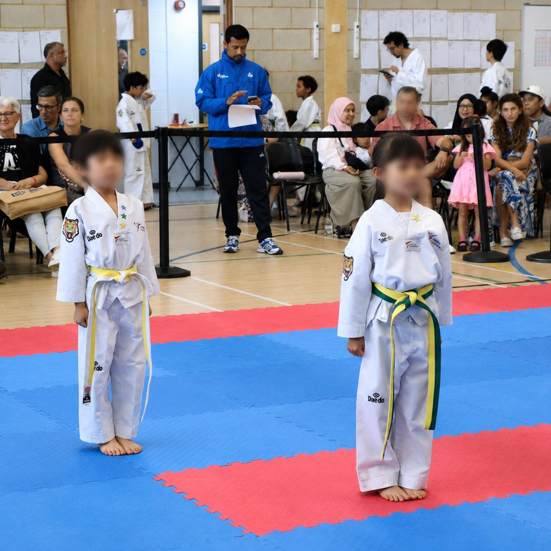 Cadets performing simultaneous high kicks in the sports hall
